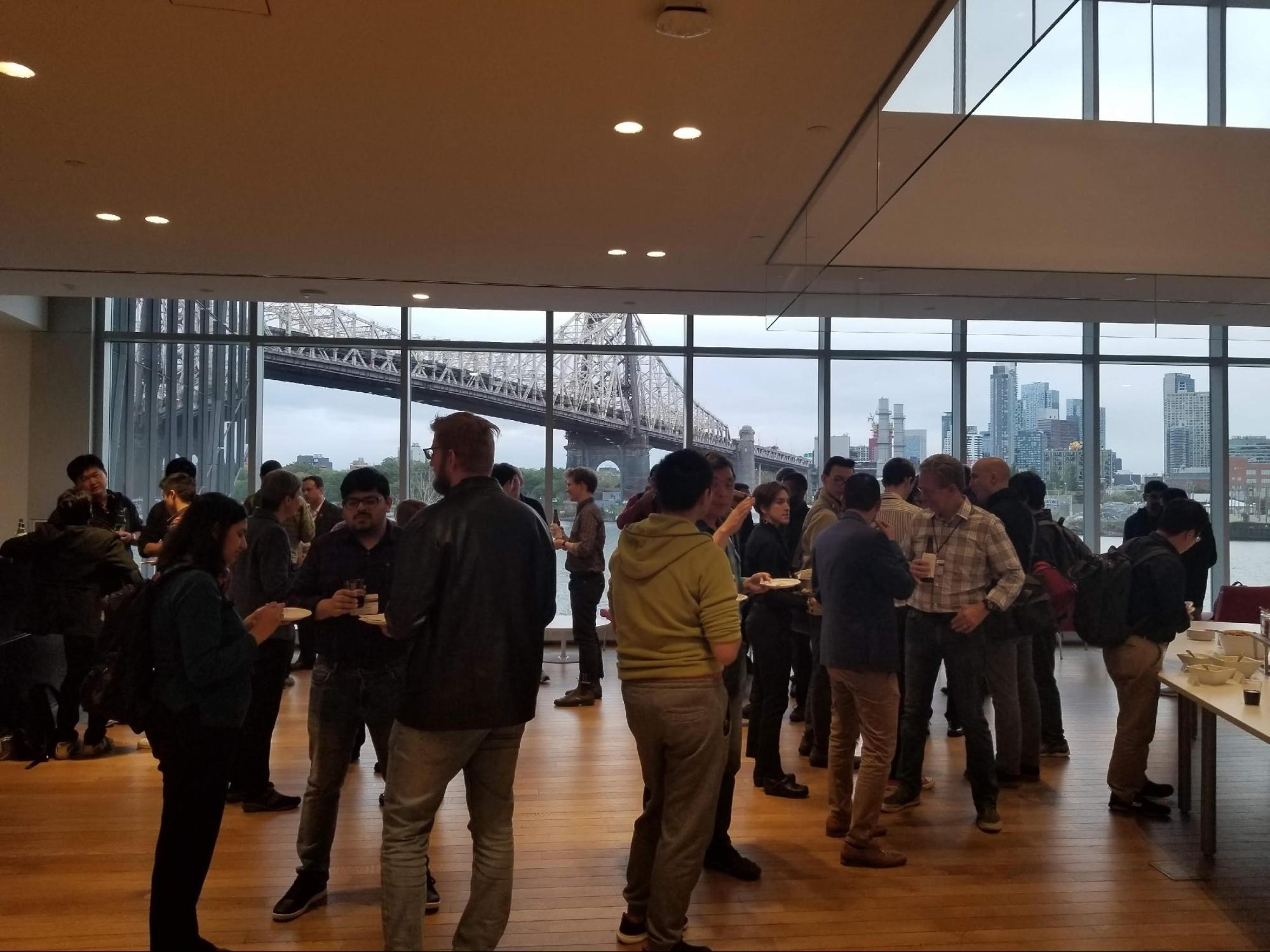 2019 NPI Fall Retreat attendees chat during the Reception at the end of the day in the Tata Innovation Center at Cornell Tech.
The Queensboro Bridge, the East River and Queens are in the background.